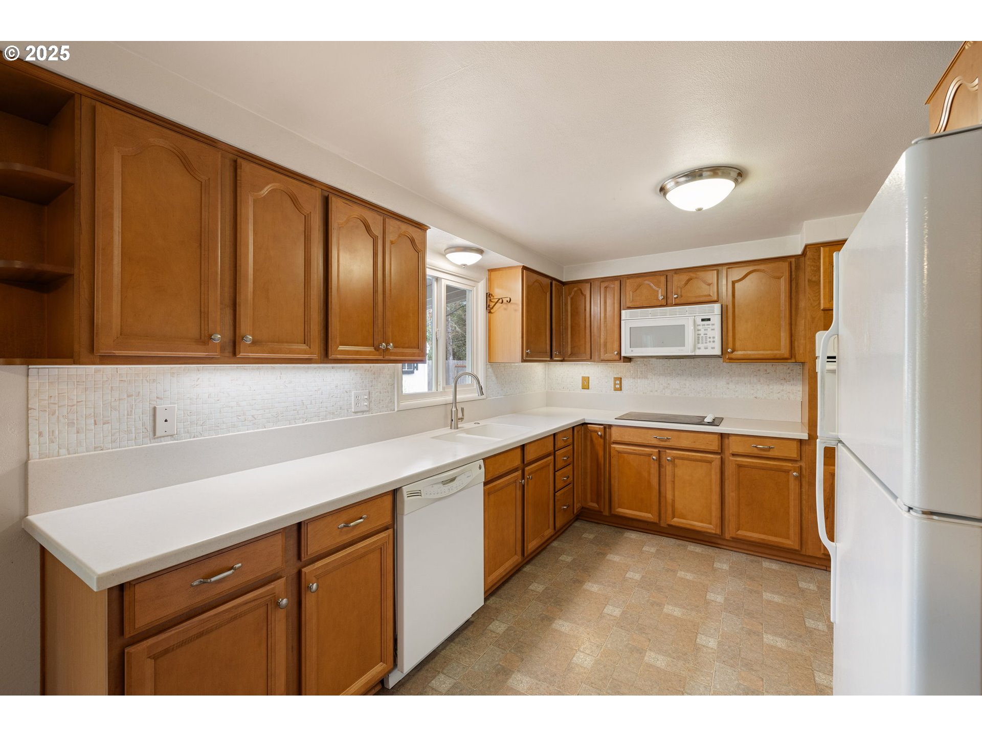 2030 Valhalla Street Eugene, OR 97401 - Photo 16 of 45 a kitchen with a sink dishwasher stove and refrigerator