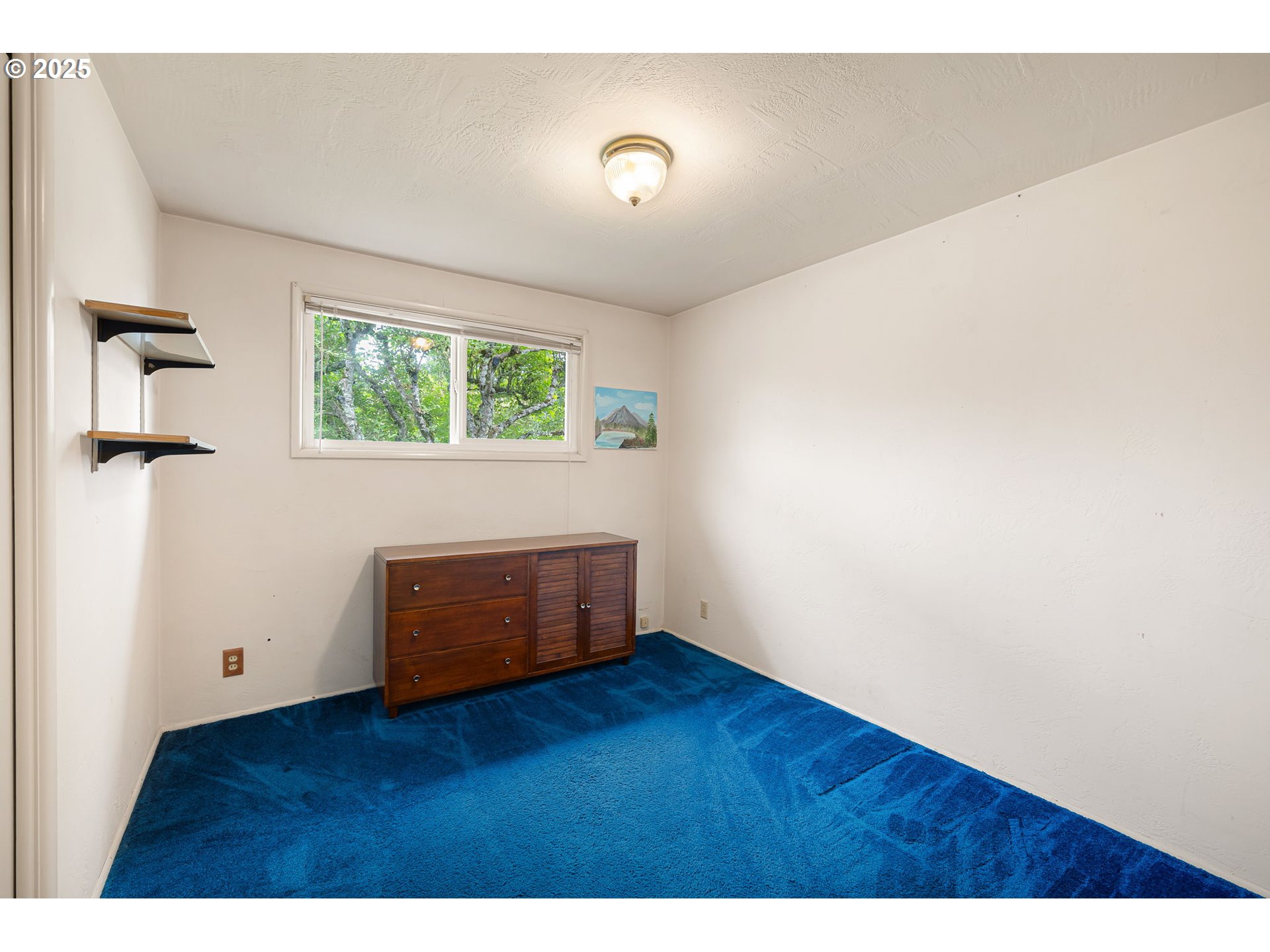 2030 Valhalla Street Eugene, OR 97401 - Photo 26 of 45 a view of an empty room with wooden floor and a window
