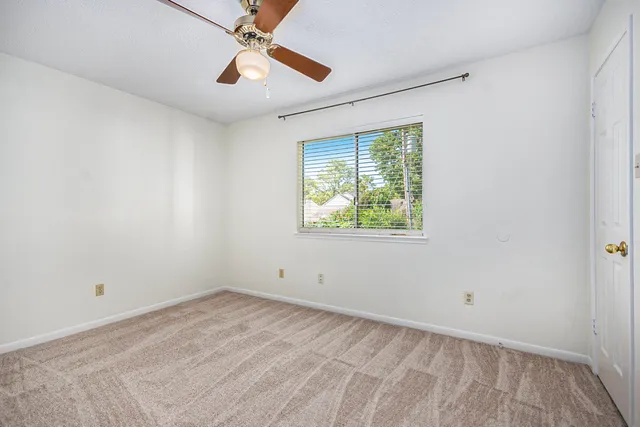 a view of room with hardwood floor and ceiling fan