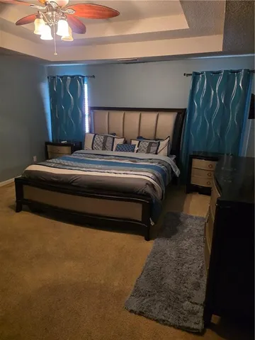 a bedroom with a bed lamp and a fireplace