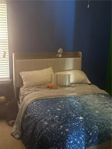 a bedroom with a bed and window