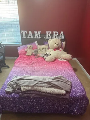 a bed sitting in a bedroom next to a window