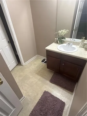 a bathroom with a sink vanity and a mirror