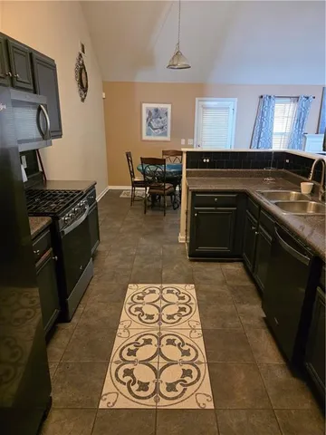 a kitchen with granite countertop a stove and cabinets