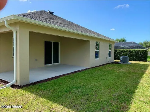 a view of a house with a backyard
