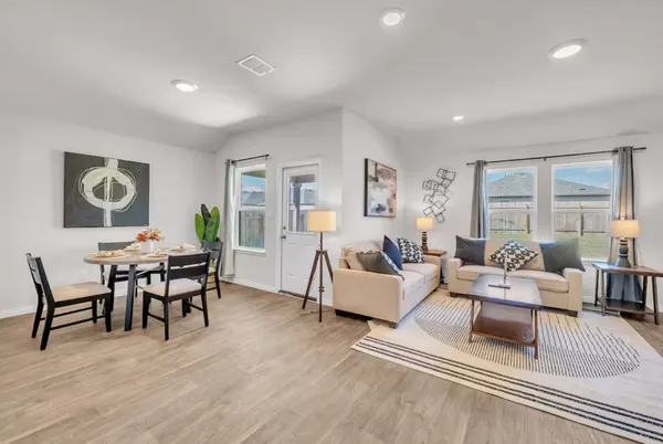a living room with furniture wooden floor and window