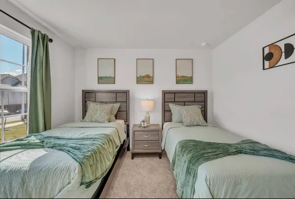 a bedroom with a bed and a night stand