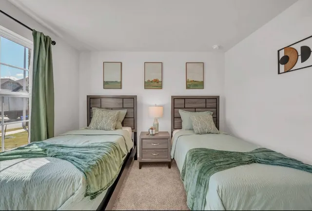 a bedroom with a bed and a night stand