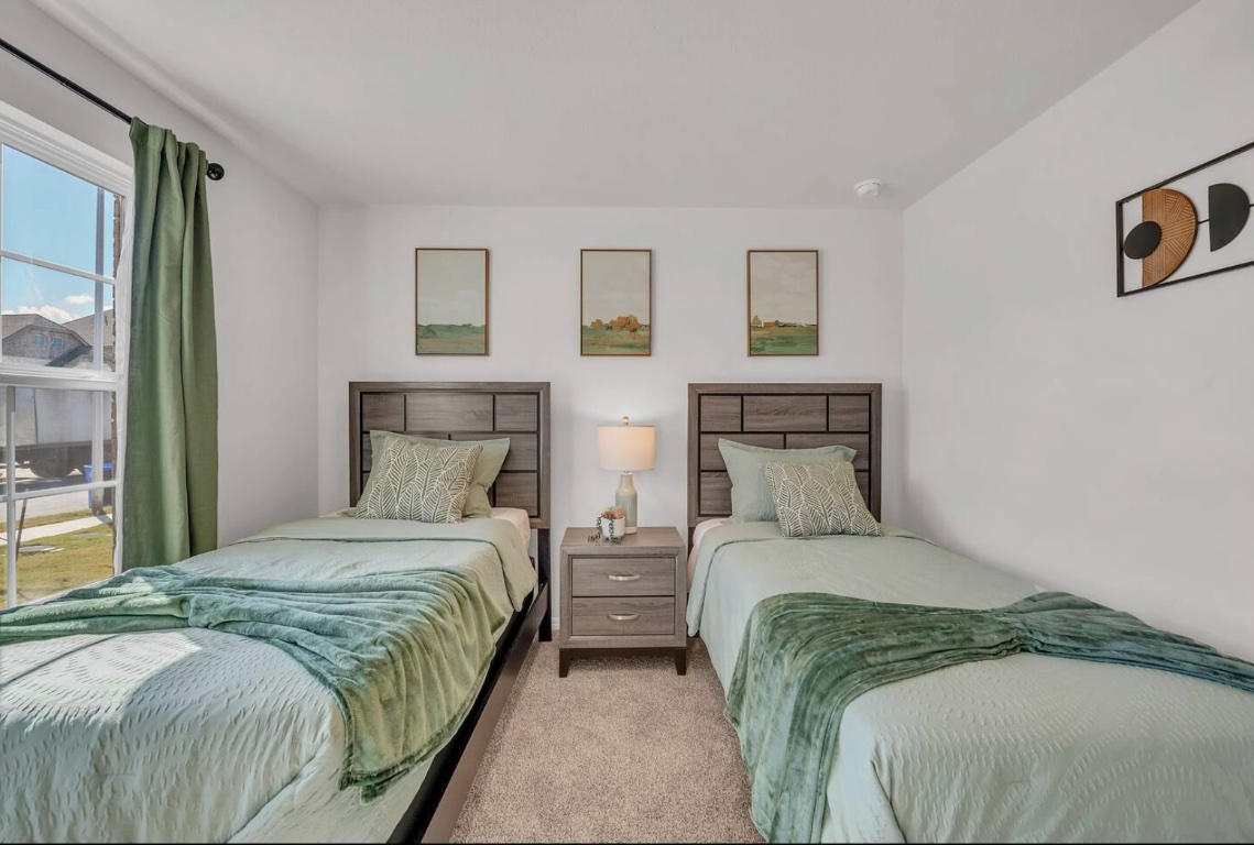 13804 Bothwell Place Manor, TX 78653 - Photo 5 of 7 a bedroom with a bed and a night stand