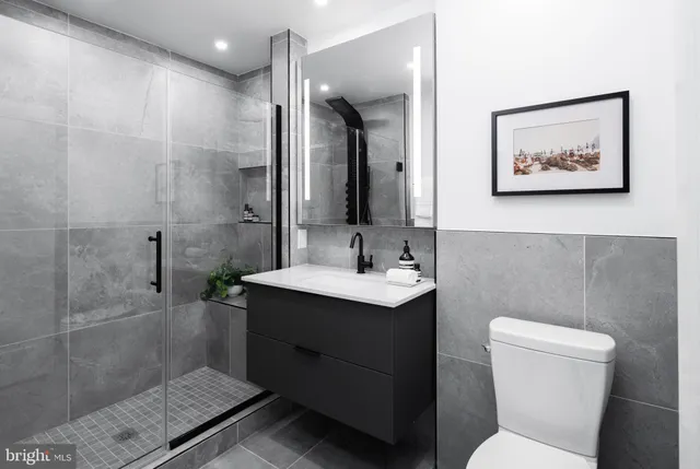 a bathroom with a toilet sink and mirror