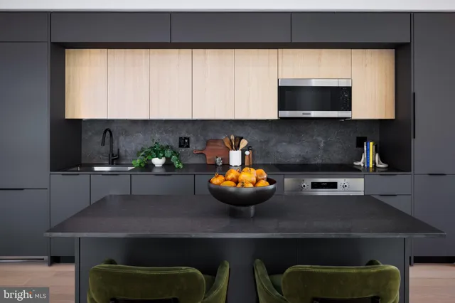 a kitchen with a sink a microwave and cabinets