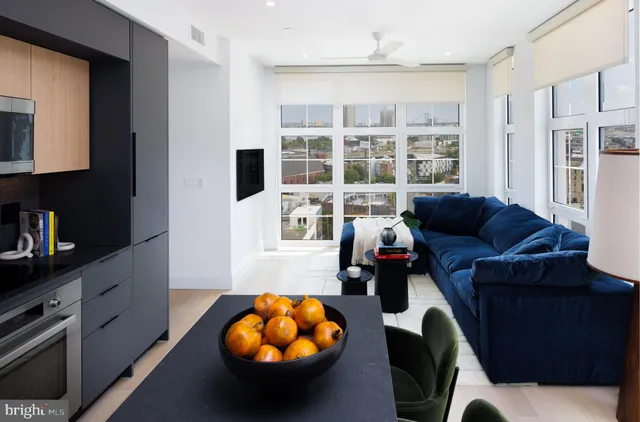 a living room with furniture a rug and a large window