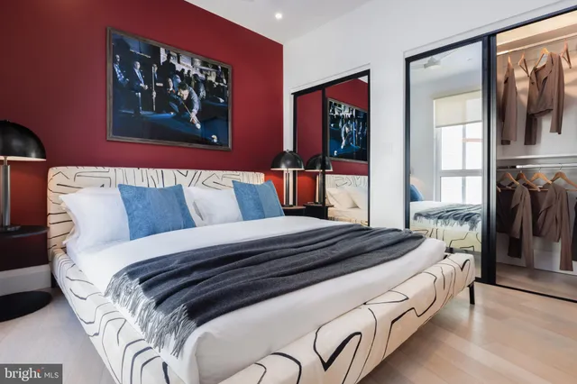 a bedroom with bed and wall painting on the wall