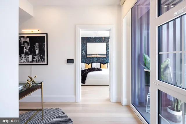 a bedroom with furniture and a mirror