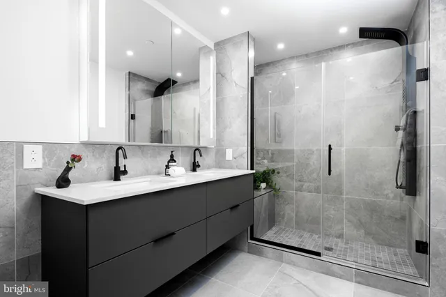 a bathroom with a shower sink and mirror