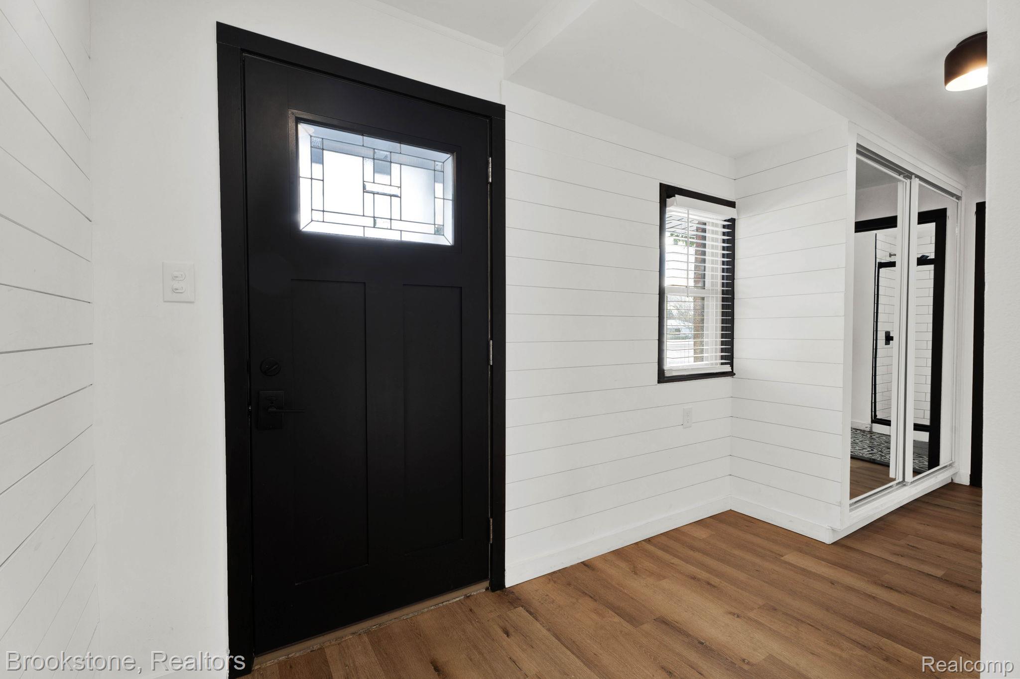 16046 West 13 Mile Road Franklin, MI 48025 - Photo 4 of 31 Foyer featuring plenty of natural light, wood walls, and wood finished floors