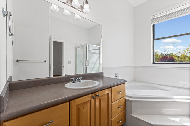 70 North Main Street, Unit 213 Bountiful, UT 84010 - Photo 11 of 15 Big and bright bathroom with a soaking tub and there is a large walk in shower to the left.
