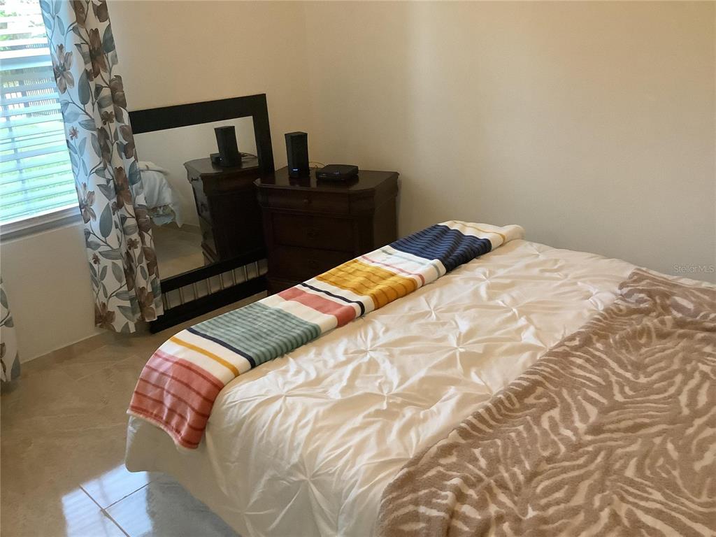 1150 North Dean Road Orlando, FL 32825 - Photo 13 of 16 a bedroom with a bed and a window