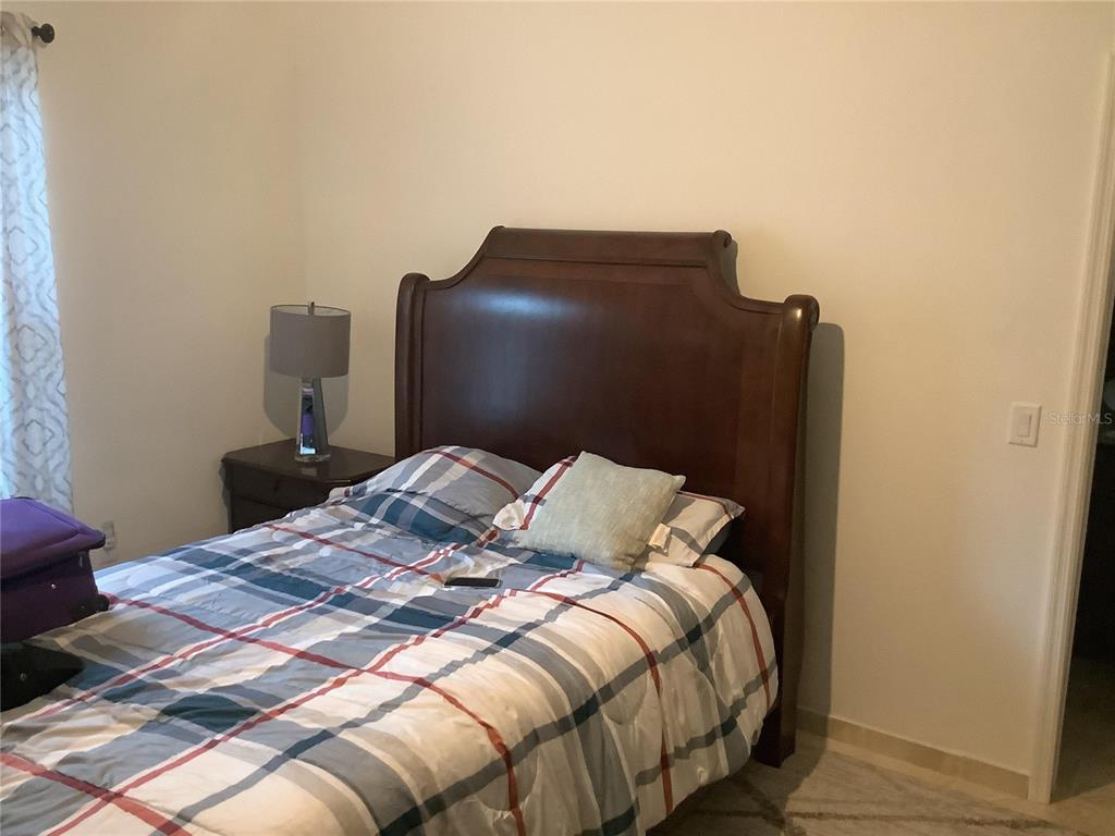 1150 North Dean Road Orlando, FL 32825 - Photo 15 of 16 a bedroom with a bed and a mirror