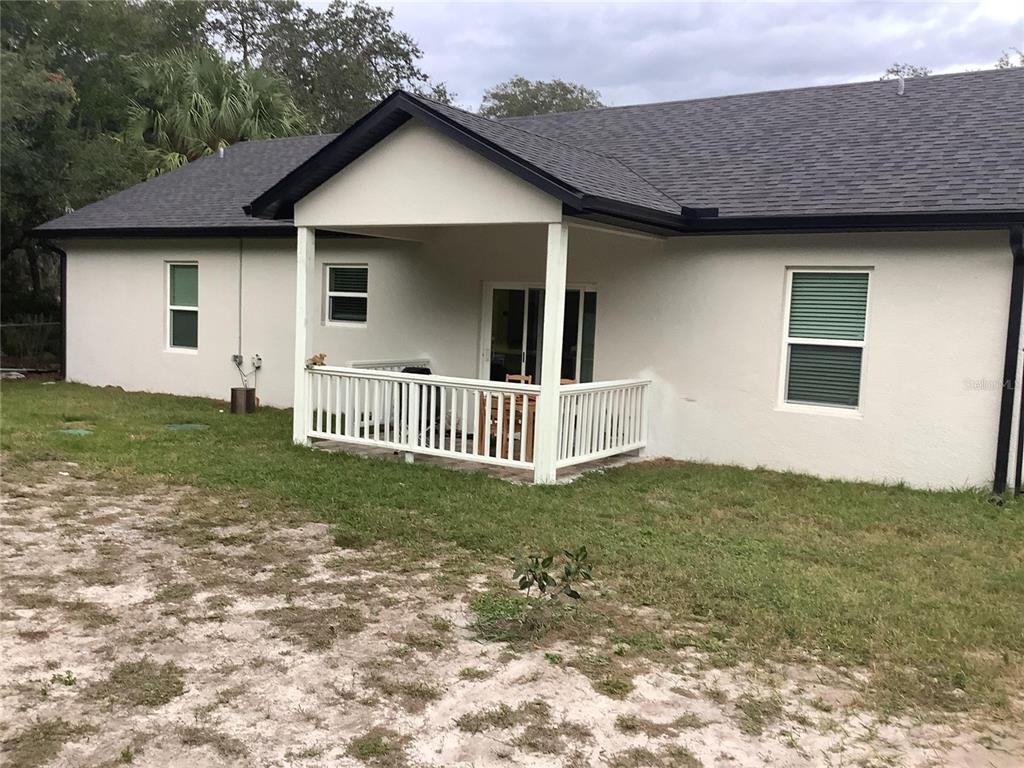 1150 North Dean Road Orlando, FL 32825 - Photo 6 of 16 a view of a house with a yard and deck