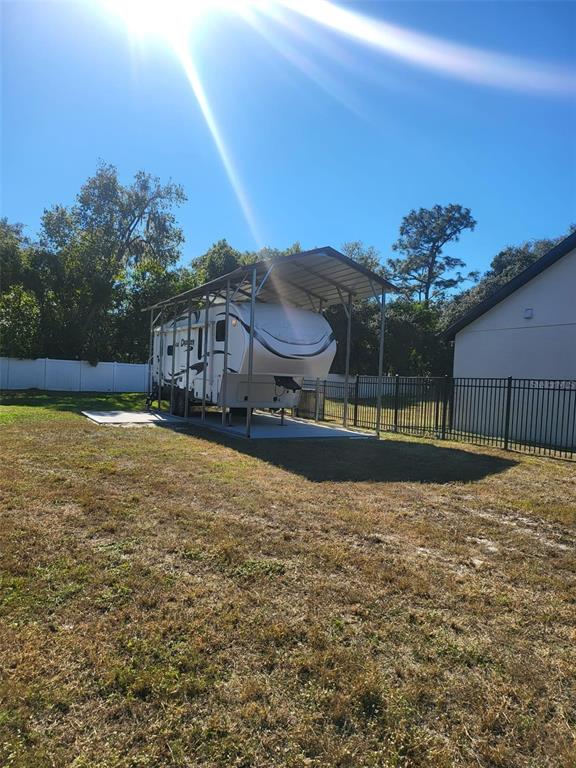1150 North Dean Road Orlando, FL 32825 - Photo 7 of 16 a view of a house with a swimming pool and a yard
