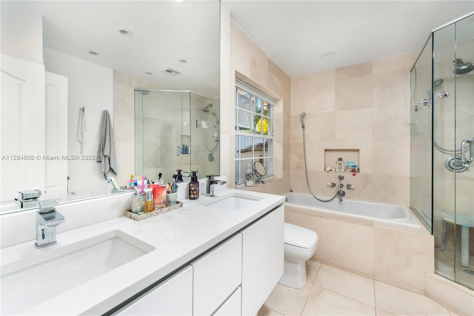 749 Ridgewood Road Key Biscayne, FL 33149 - Photo 17 of 34 a bathroom with a sink a toilet and shower