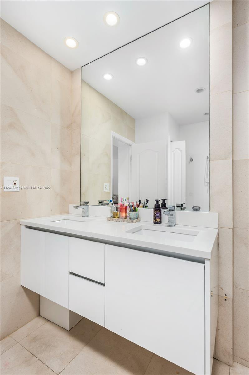 749 Ridgewood Road Key Biscayne, FL 33149 - Photo 18 of 34 a bathroom with a sink and a mirror