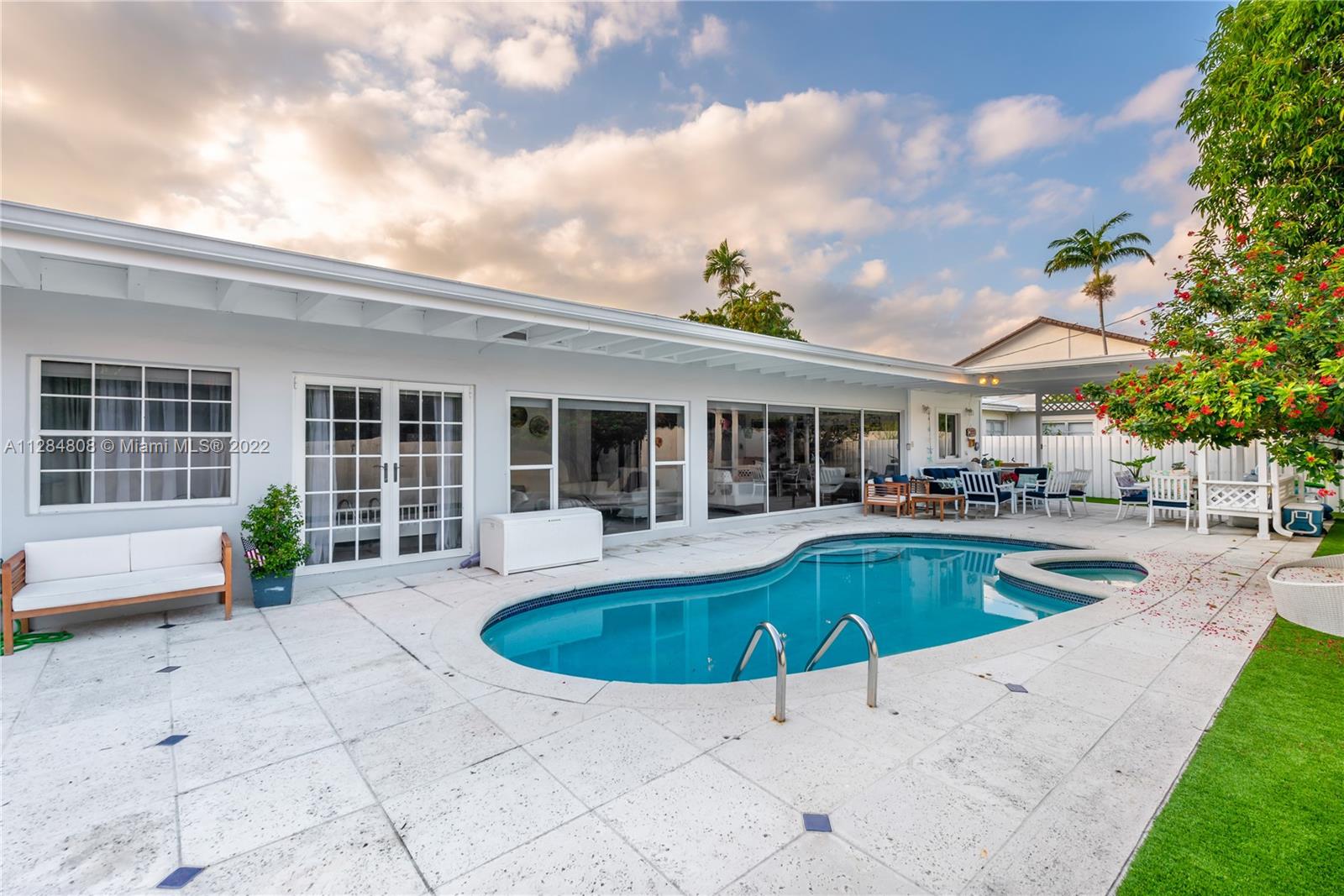 749 Ridgewood Road Key Biscayne, FL 33149 - Photo 28 of 34 a view of a house with swimming pool and sitting area