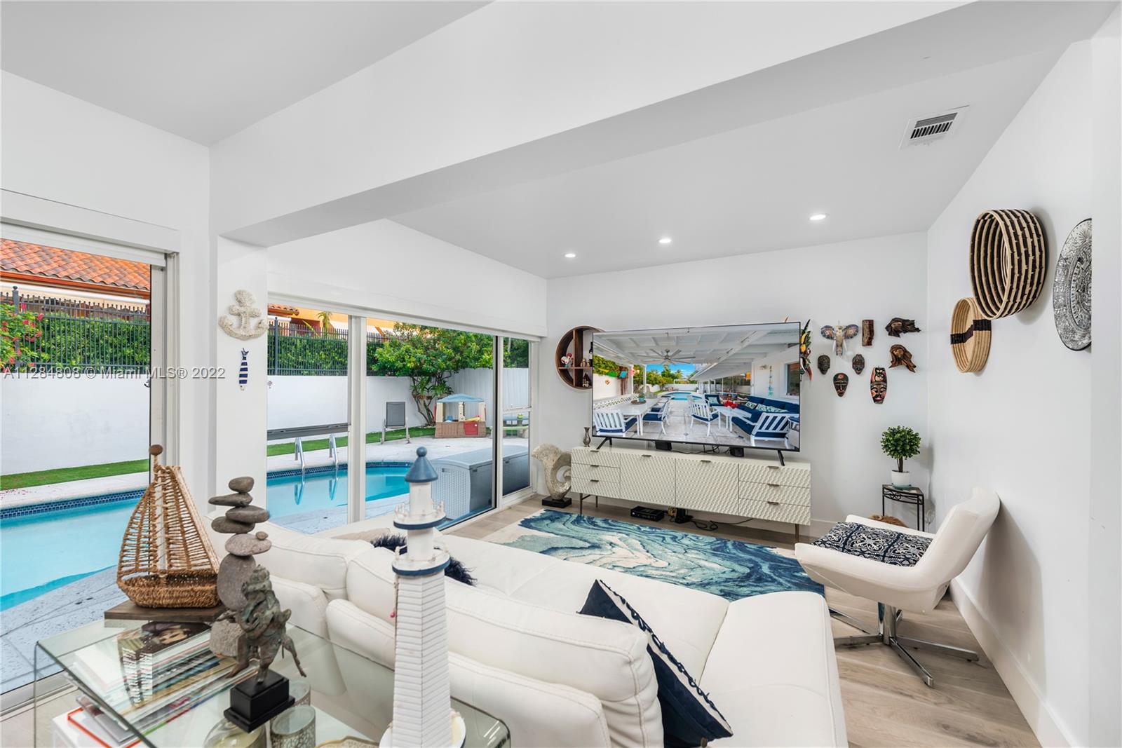 749 Ridgewood Road Key Biscayne, FL 33149 - Photo 8 of 34 a living room with furniture and a floor to ceiling window