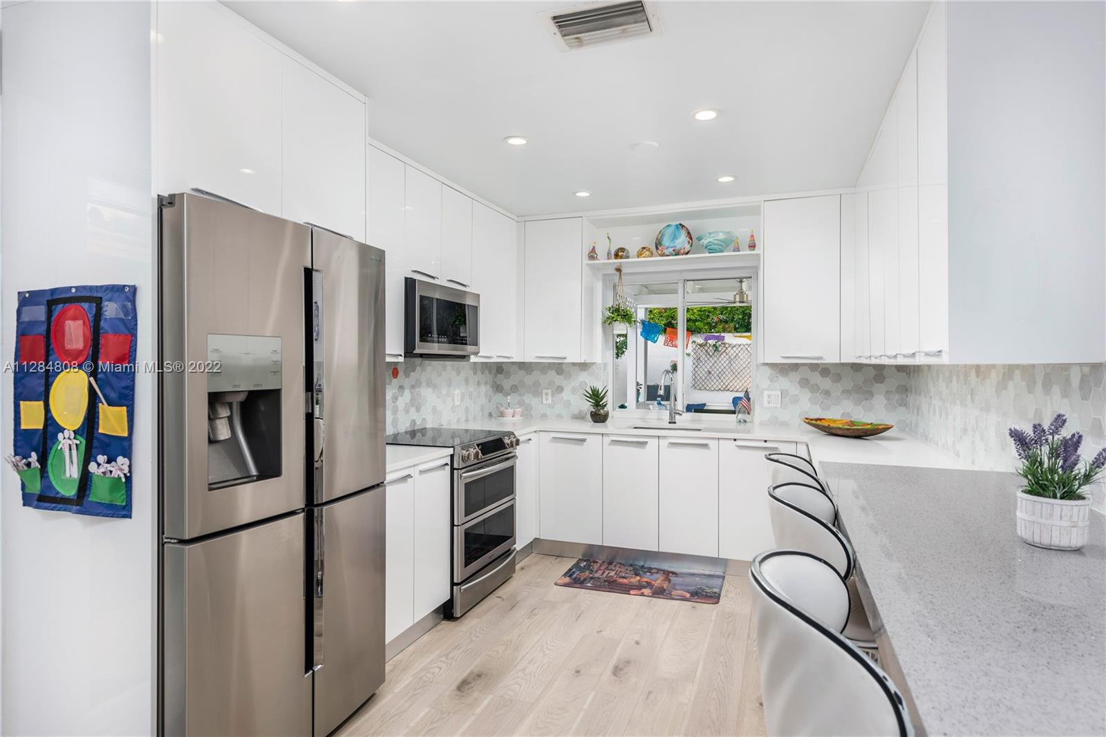 749 Ridgewood Road Key Biscayne, FL 33149 - Photo 9 of 34 a kitchen with stainless steel appliances granite countertop a refrigerator sink and stove