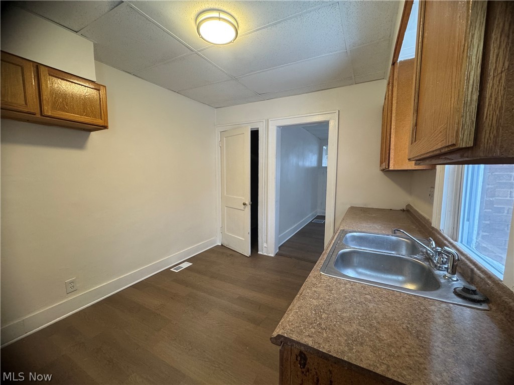 3242 Sycamore Road, Unit LEFT SIDE Cleveland Heights, OH 44118 - Photo 9 of 20 Kitchen featuring wood finish cabinetry, dark wood-style floors, a drop ceiling, and dark countertops