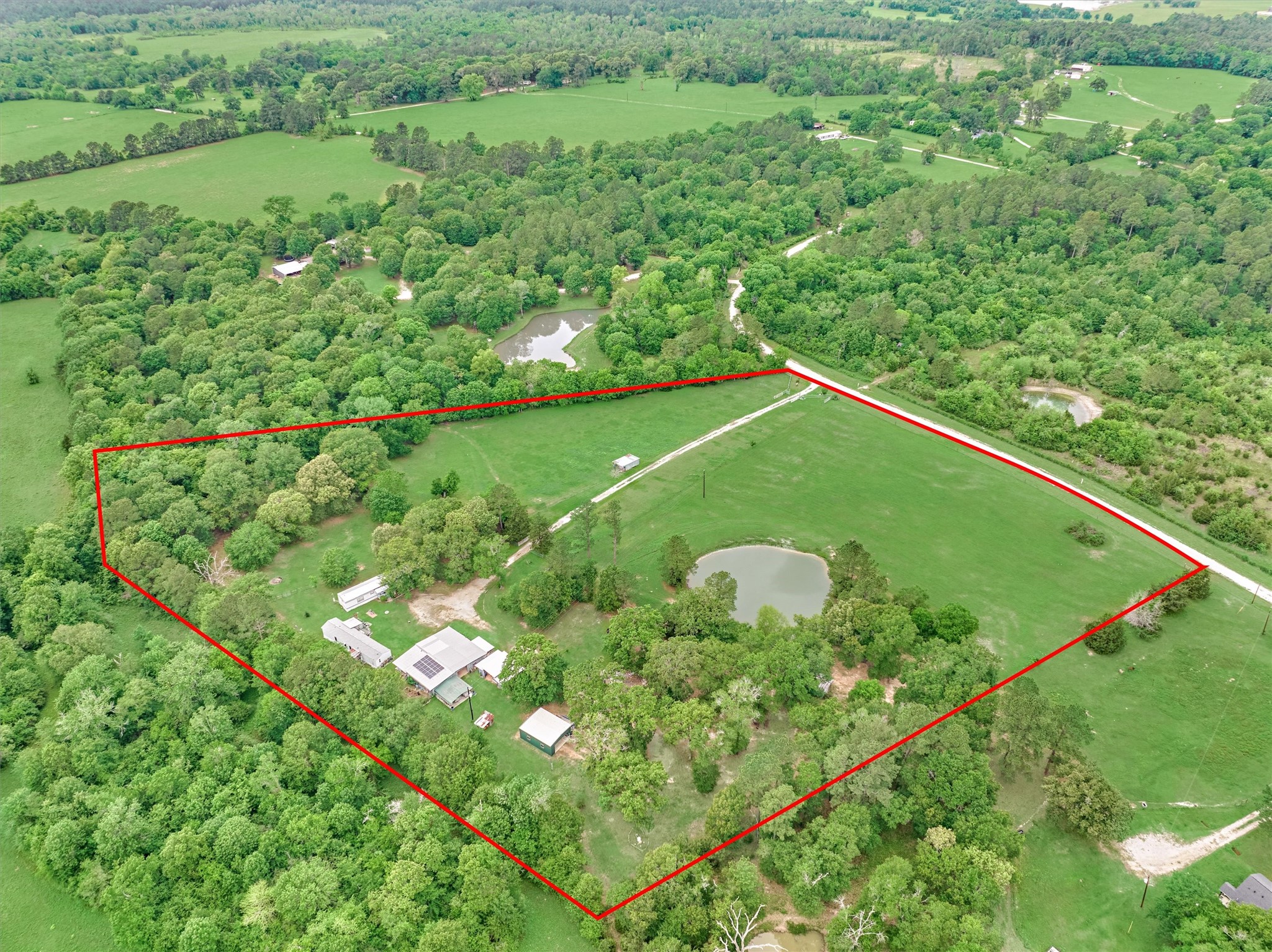 Peaceful Pond, Multiple Fenced in Areas, Barn with Plumbing, Spacious Metal Shop!