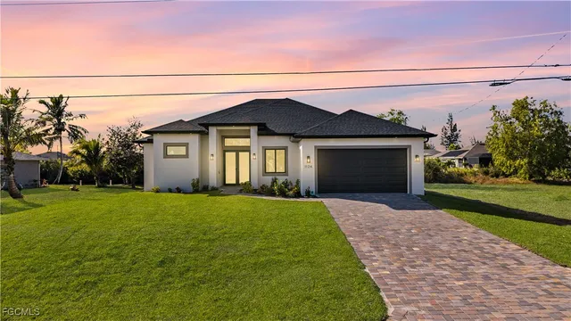a front view of house with yard and green space