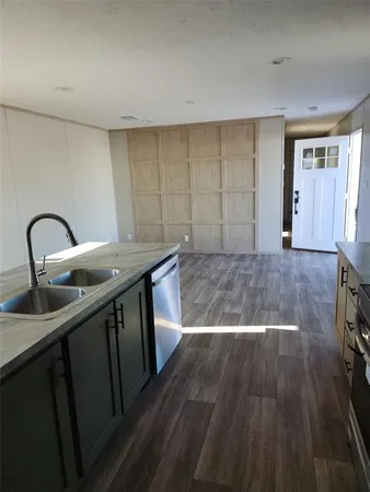 a view of a kitchen with wooden floor and sink