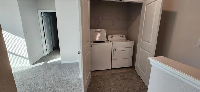 a view of storage and utility room with washer and dryer