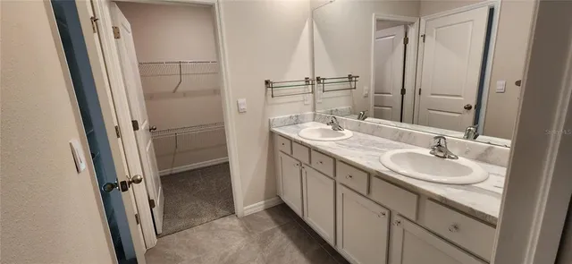 a bathroom with 2 sink and a mirror