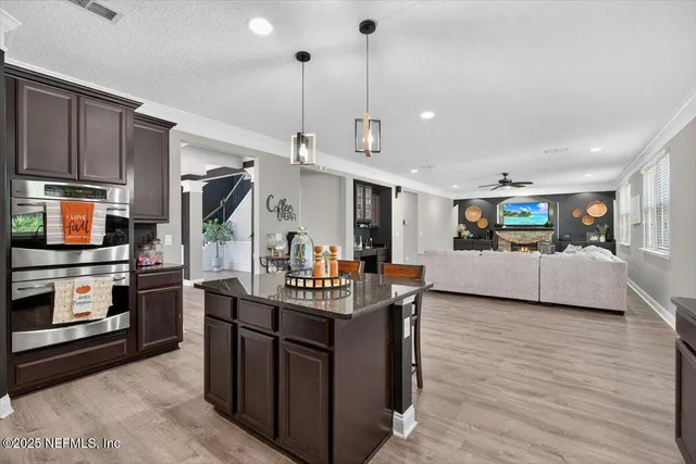 a living room with furniture and a ceiling fan