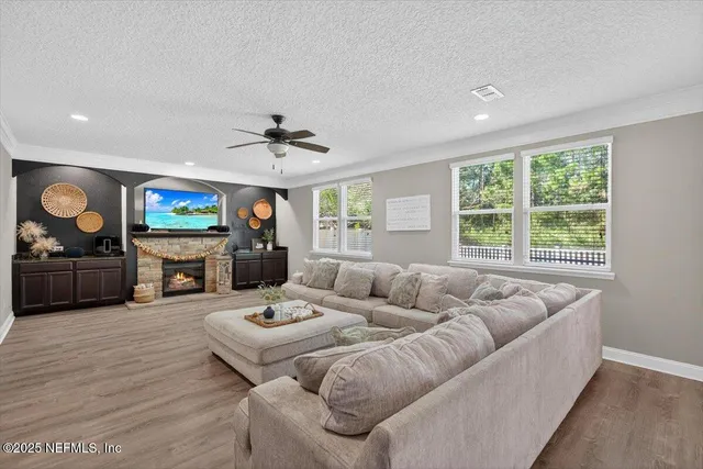a spacious bedroom with a bed a dresser and a window
