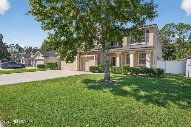 a front view of a house with a yard and garage