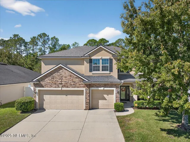 a living room with furniture a wooden floor and a fireplace