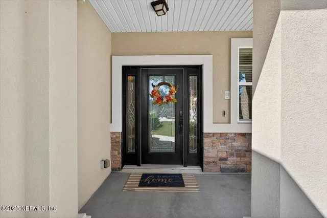 a living room with furniture a rug and a clock
