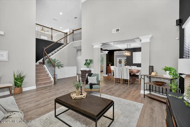 a view of a dining room with furniture and chandelier