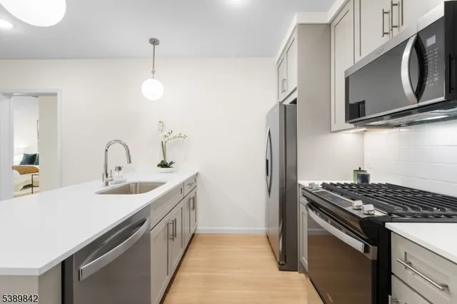 a kitchen that has a sink and a stove top oven