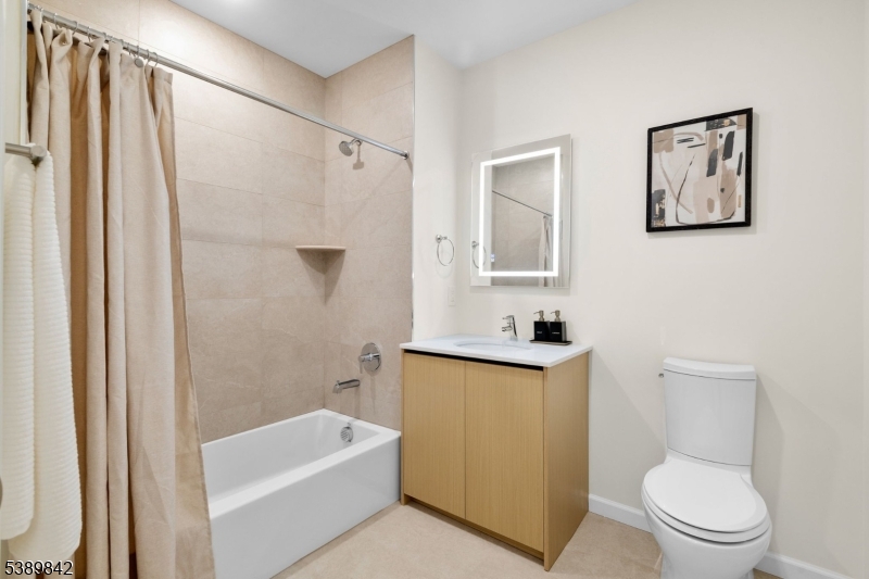 70 Ridgedale Avenue, Unit 205 Morristown, NJ 07960 - Photo 11 of 20 a bathroom with a sink a toilet and shower