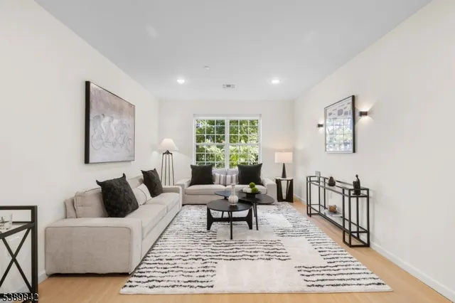 a living room with furniture a rug and a window