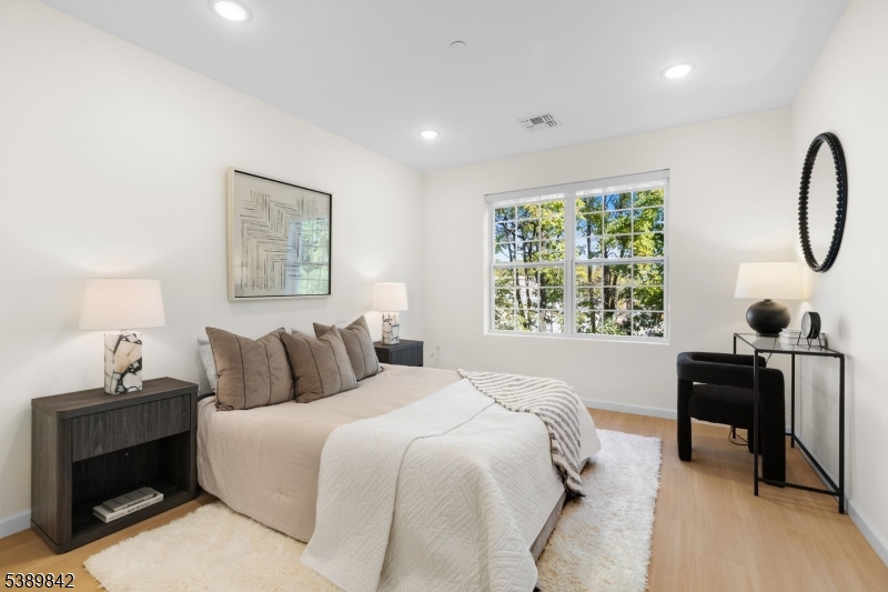 70 Ridgedale Avenue, Unit 205 Morristown, NJ 07960 - Photo 9 of 20 a bedroom with a bed and a table