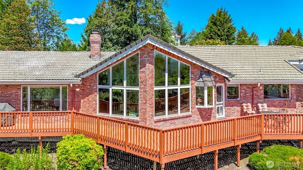 a view of a house with a deck and a yard