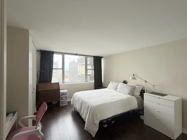 a bedroom with a bed and windows