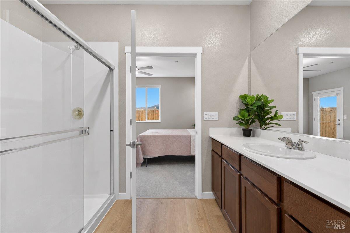2275 Revival Lane Rio Vista, CA 94571 - Photo 16 of 31 a en suite bathroom with a granite countertop sink and a mirror
