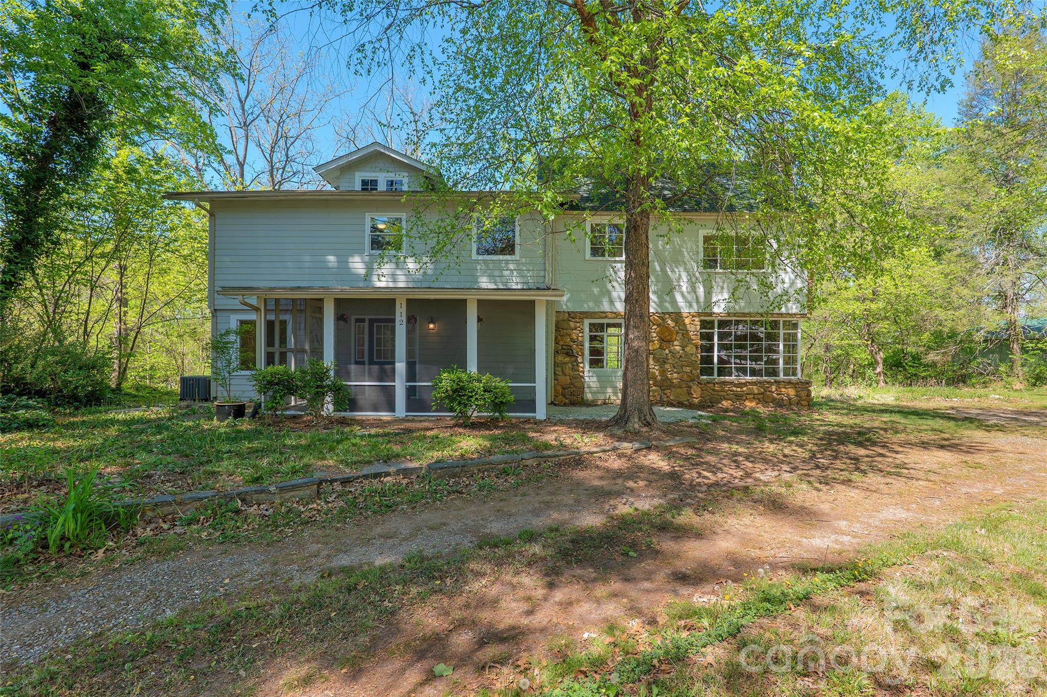 112 Candler School Road Candler, NC 28715 - Photo 2 of 37 a front view of a house with a garden